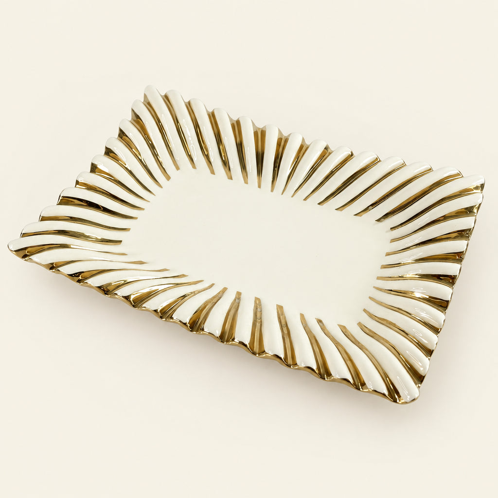 Gold Ray 14-inch rectangular white porcelain serving tray with a fluted gold sunburst rim, on grey marble