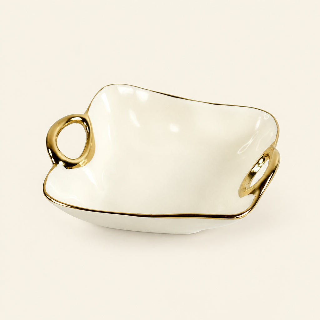 Gold Loop 7-inch cream porcelain catch tray with gold trim and two loop handles, on white marble