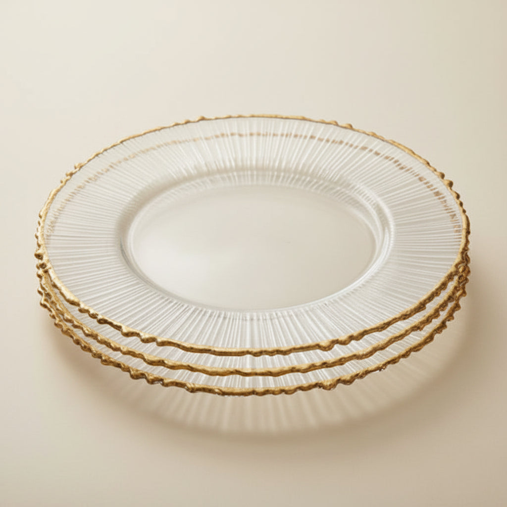 A collage showing clear ribbed glass charger plates with a scalloped gold rim, including a close-up of the plate edge, a stack of plates on a wooden table, and the plates styled on a table setting with white dinnerware and gold cutlery.