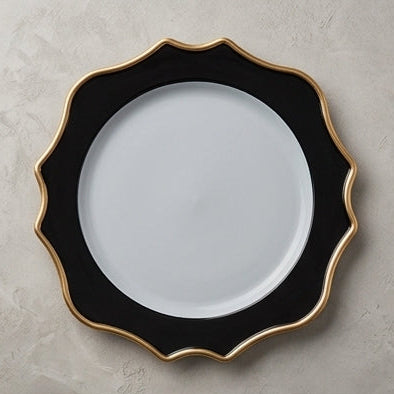A set of scalloped dinner plates in a black and white colorway with a gold accent trim, shown in multiple views including close-ups and a styled table setting.